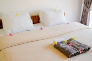 Ekas room bed setup at LMBK Surf House Lombok