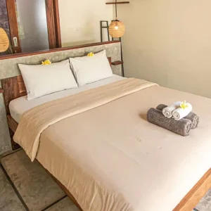 Seger room bed and furnishings at LMBK Surf House Lombok