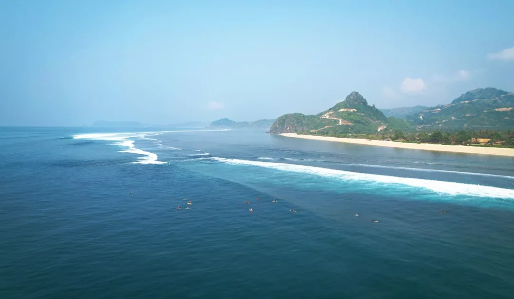Surfers surfing Serangan Kuta Lombok