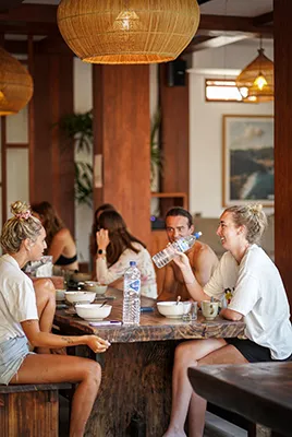 LMBK Surf House guests enjoying family dinner at the LMBK Surf Camp in Kuta Lombok