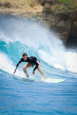 LMBK Surf House Guest riding a wave in Kuta Lombok