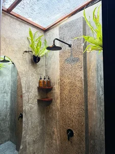 4-bed dorm shower at LMBK Surf House Lombok